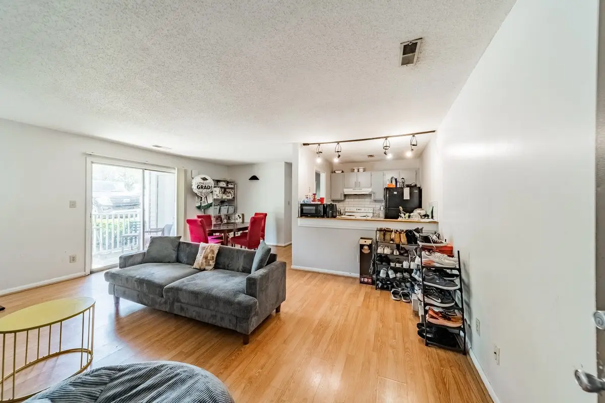 Open-concept living room and kitchen in a professionally managed UNCC Rooms rental in University City