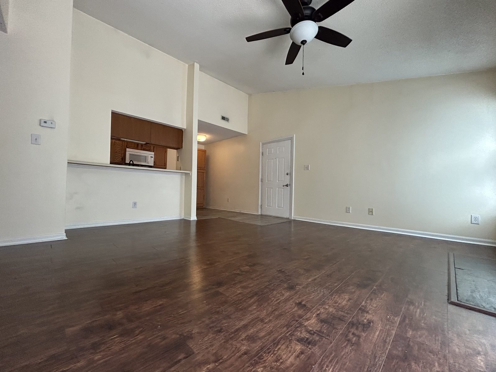 Bright vaulted-ceiling living room with kitchen pass-through in a University City co-living rental near UNC Charlotte